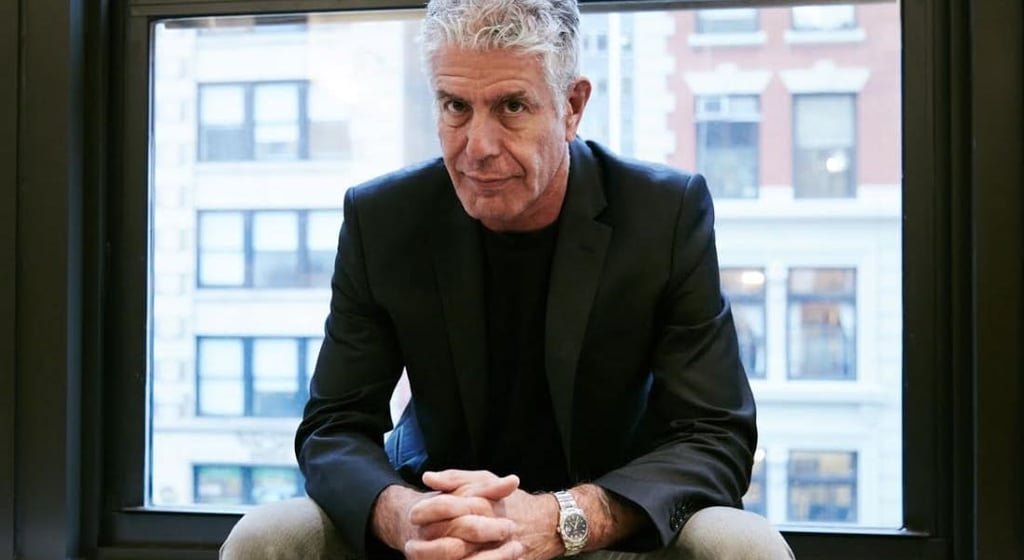 A man sitting in front of a window