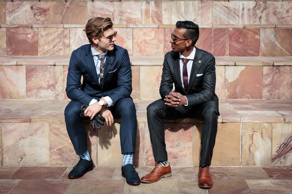 A man in a suit and tie sitting on a bench