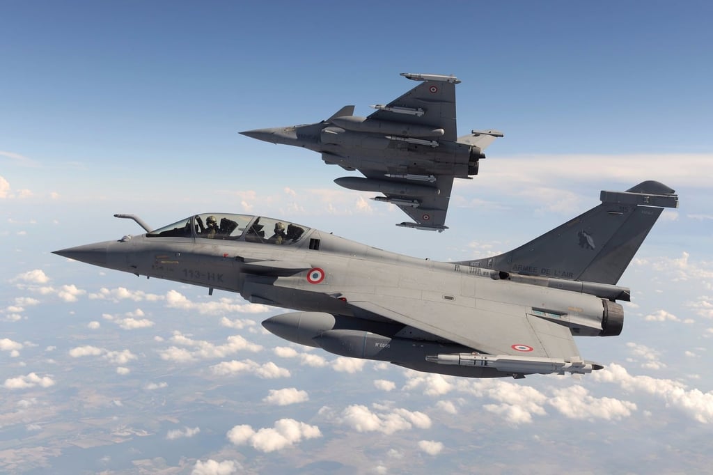 A fighter jet flying through a blue sky