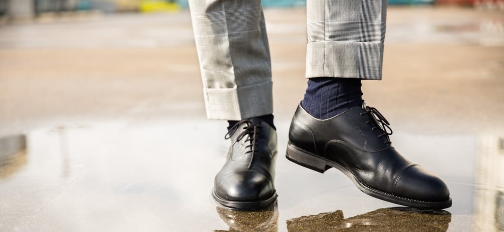 A pair of feet wearing blue shoes