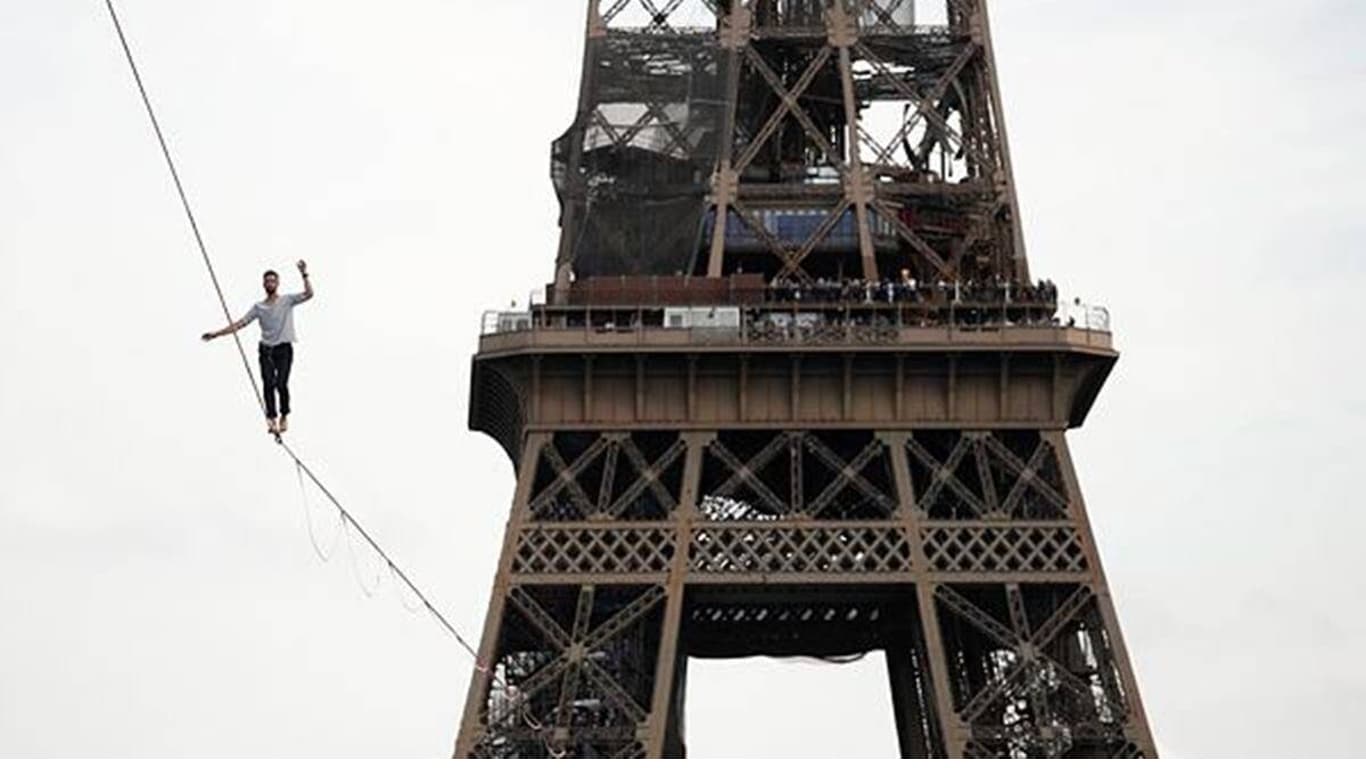 French Slackliner Nathan Paulin Crosses Seine River From Eiffel Tower